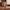 On the Wings of a Dove memorial urn on a wooden dresser with greenery in a tall gold flute vase