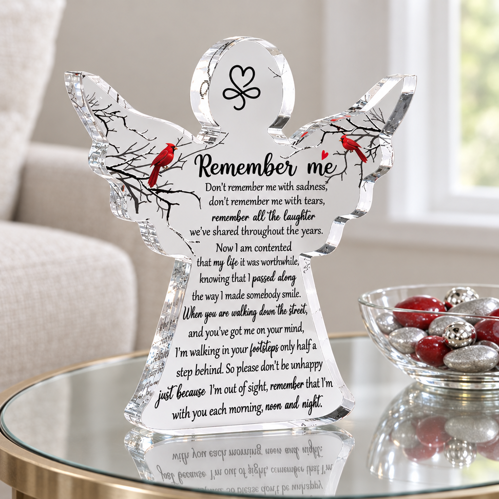 Cardinal angel acrylic keepsake on a glass table beside a bowl of red and silver decorative stones and balls; props not included